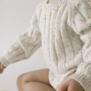 Organic speckled ribbed romper made from soft natural cotton, featuring snap buttons for easy nappy changes. Ethically made and comfy for all seasons.