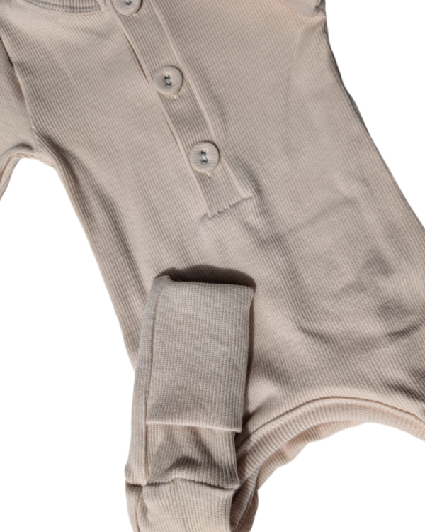Organic cotton onesie and matching beanie set neatly packaged, ready for gifting or personal use.