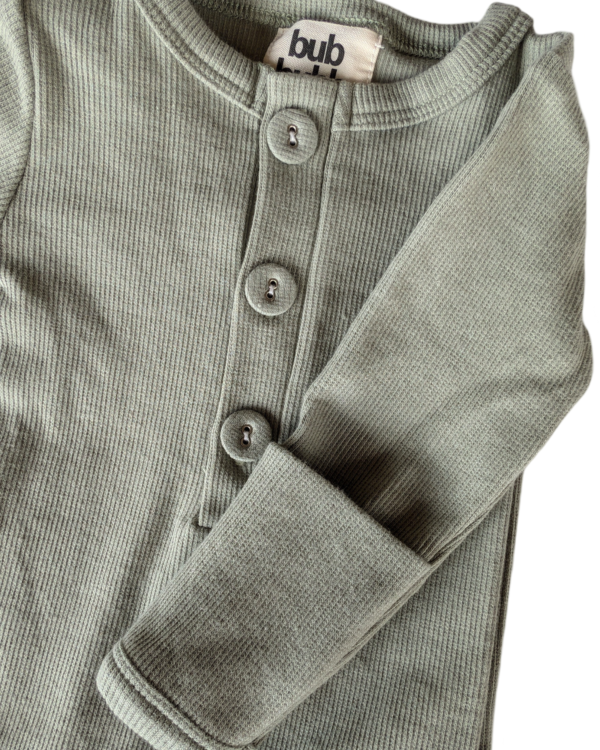 Close-up of the soft, breathable organic cotton fabric used for the onesie and beanie, gentle on baby’s skin.