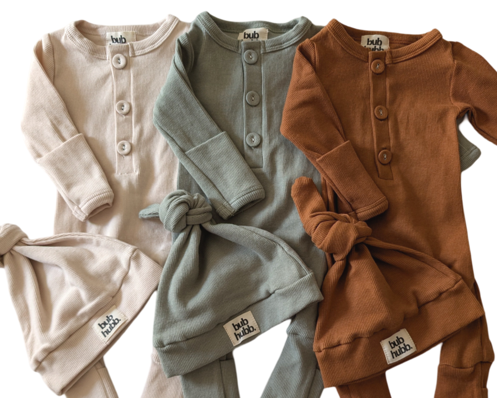 Close-up of soft 100% organic cotton onesie and beanie, ideal for keeping babies comfortable and warm.