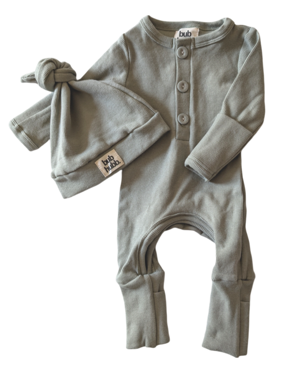 Organic cotton onesie and beanie set displayed alongside other baby essentials for a stylish look.