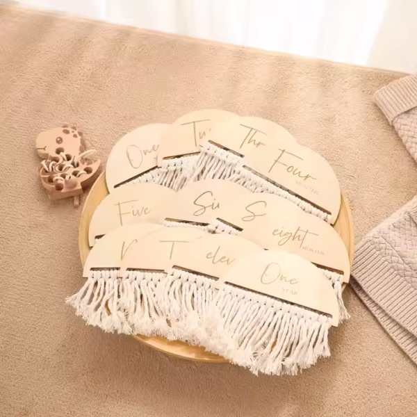 New parent holding the boho milestone set to celebrate their baby’s growth.