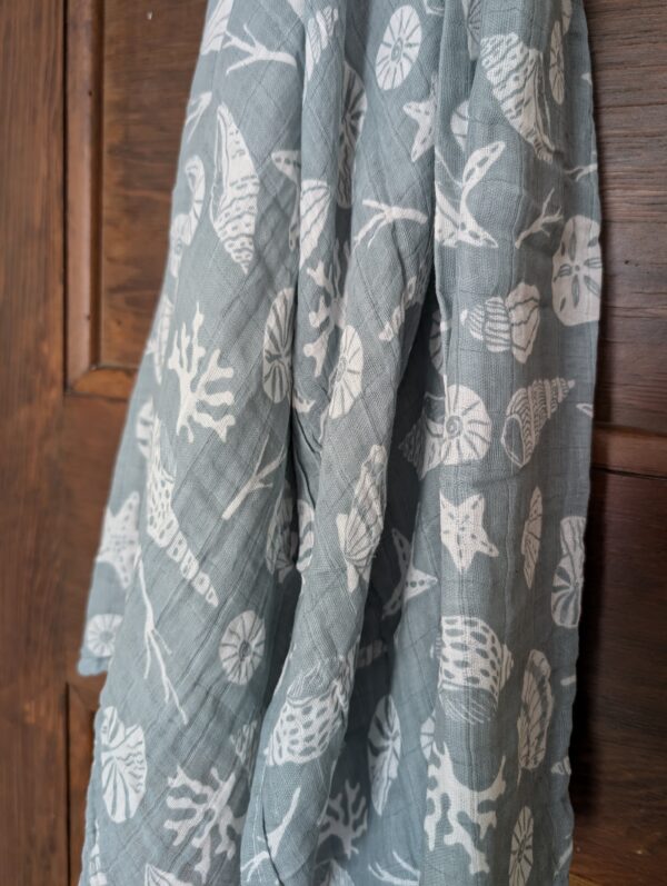 Versatile cotton muslin wrap used as a lightweight blanket for babies