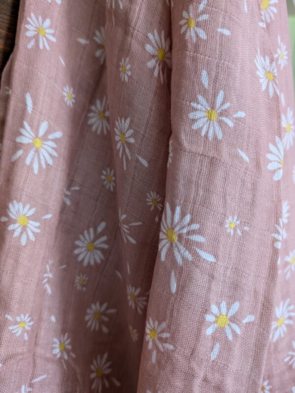 Lightweight cotton muslin swaddle neatly folded, showcasing its soft and breathable fabric.